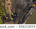 Two crawler excavators cleans the pond of silt and algae. Earthworks, cleaning of water bodies 93631659