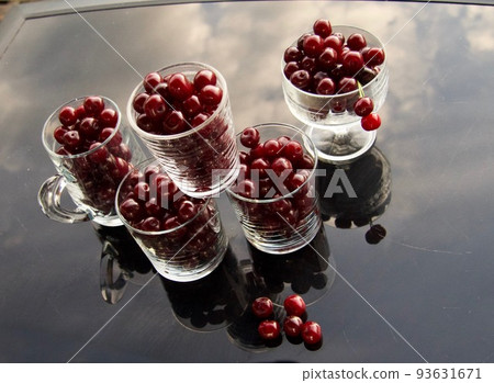 cherry compote drink on garden background 93631671