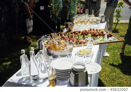 A wide variety of snacks on the table for guests. Shrimp, boiled pork, various types of meat and other products A wide variety of snacks on the table for guests. Shrimp, boiled pork, various types of meat and other products 93632097
