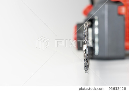 Chain saw on wood on a white background Chain saw on wood on a white background 93632426