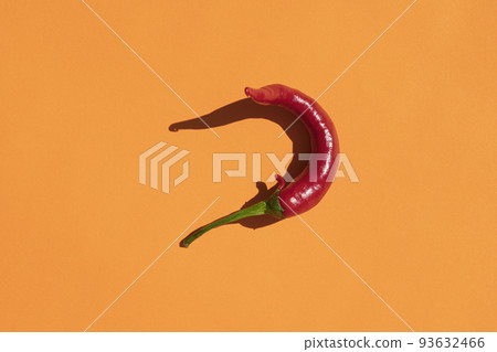 red hot pepper on a yellow background with a hard shadow red hot pepper on a yellow background with a hard shadow 93632466