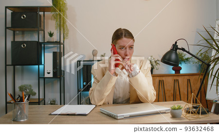 Business woman girl working, having mobile phone talk at office workplace using messenger chat apps Business woman girl working, having mobile phone talk at office workplace using messenger chat apps 93632468