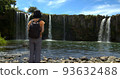 Back view of a woman looking at Harajiri Falls 93632488