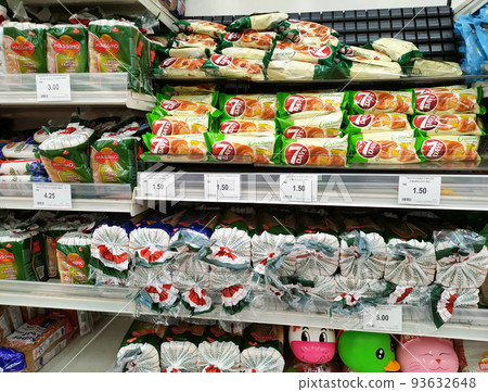 SEREMBAN, MALAYSIA -APRIL 28, 2020: Various types of bread in commercial packaging displayed on shelves for sale. Separated by type and brand to make it easier for customers to choose. 93632648