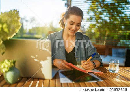 woman is working sitting on the patio woman is working sitting on the patio 93632726