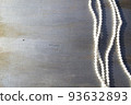 Pearl beads on a gray wooden background close-up. 93632893