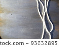 Pearl beads on a gray wooden background close-up. 93632895