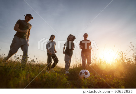 Happy family playing soccer Happy family playing soccer 93632925