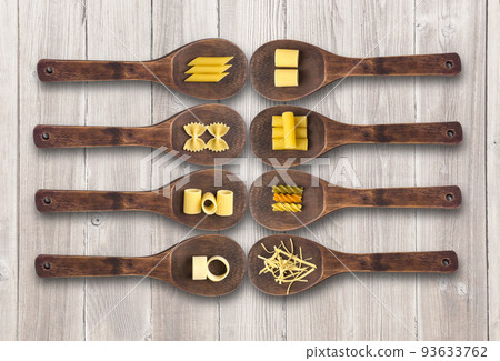 Wooden cooking spoons filled with various types dry pasta Wooden cooking spoons filled with various types dry pasta 93633762