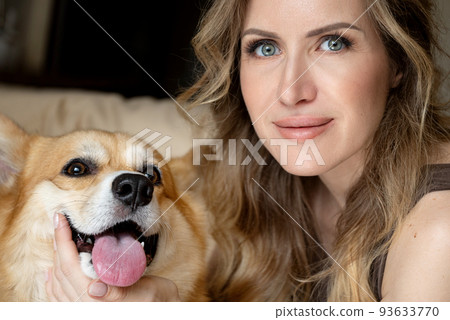 young woman with cute corgi dog smiling looking at camera close up portrait young woman with cute corgi dog smiling looking at camera close up portrait 93633770
