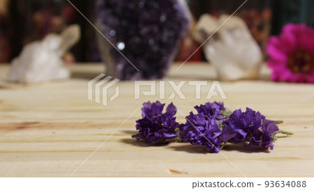 Amethyst Crystals With Flowers on Meditation Table 93634088