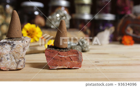 Incense Cones and Chakra Stones With Flowers in Background Shallow DOF Incense Cones and Chakra Stones With Flowers in Background Shallow DOF 93634096