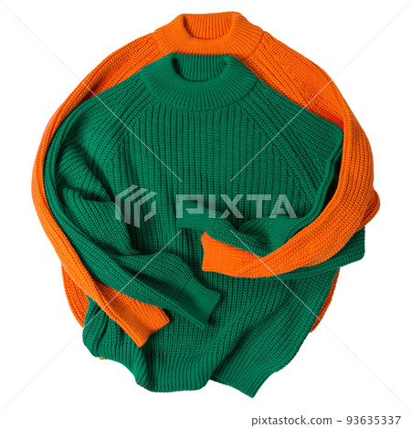 Two colored knitted sweaters lie side by side, as if in an embrace, on a white background 93635337