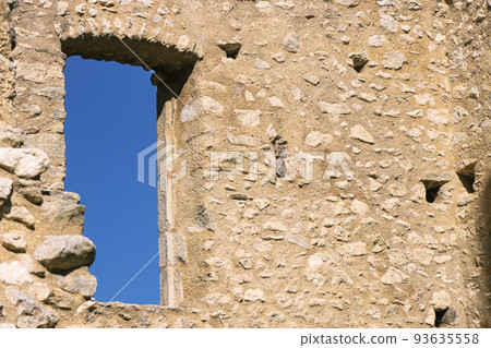 View of blue sky outside a window of 12th century French castle ruins View of blue sky outside a window of 12th century French castle ruins 93635558