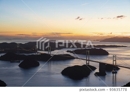 Shimanami Kaido and Kurushima Kaikyo Bridge at sunset seen from Kirosan Observatory Park on Oshima, Seto Inland Sea, Ehime Prefecture in summer 93635778
