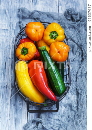 Zucchini and peppers in the basket Zucchini and peppers in the basket 93637687