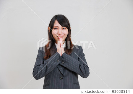 A woman in a suit making a cute wish A woman in a suit making a cute wish 93638514