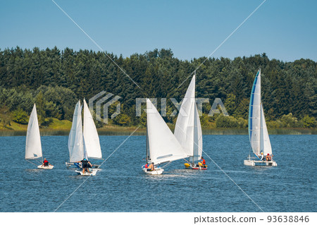 Lots of white boats sailing on the lake Lots of white boats sailing on the lake 93638846