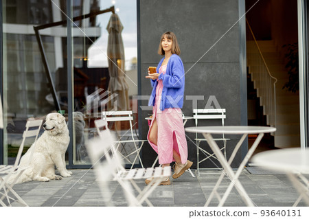 Woman with dog at cafe outdoors 93640131