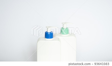 Two white plastic bottles with black dispenser, isolated on white background Two white plastic bottles with black dispenser, isolated on white background 93641083