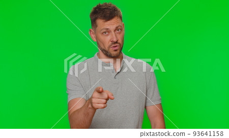 Handsome young man pointing to camera and looking with playful happy expression, making choice Handsome young man pointing to camera and looking with playful happy expression, making choice 93641158
