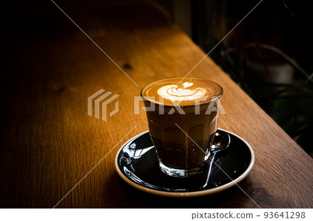A cup of coffee latte top view with leaf shape foam A cup of coffee latte top view with leaf shape foam 93641298