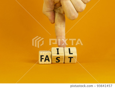 Fail fast symbol. Concept words Fail fast on wooden cubes. Businessman hand. Beautiful orange table orange background. Business and fail fast concept. Copy space. Fail fast symbol. Concept words Fail fast on wooden cubes. Businessman hand. Beautiful orange table orange background. Business and fail fast concept. Copy space. 93641457