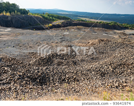 Basalt quarry. Marks of excavator operating in a rock quarry. 93641974