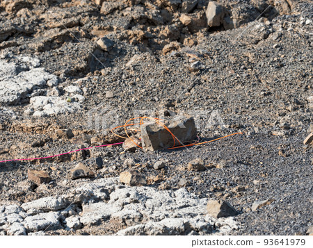 Explosive works, drilled rocks stuffed with explosives and colorful ignition lines Explosive works, drilled rocks stuffed with explosives and colorful ignition lines 93641979