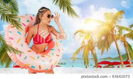 Amazed woman exits from an inflatable donut 93642073