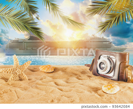 Beach with seashells, starfish, retro camera and a cruiseship 93642084