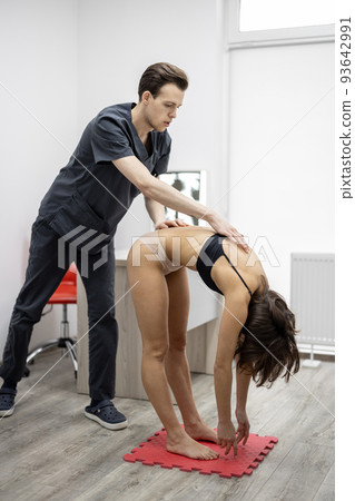 Woman on examination by physical therapist Woman on examination by physical therapist 93642991