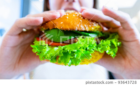 Hamburger vegan healthy vegetarian burger. Salad, avocado, vegetable on veggie sandwich eating cute woman. Tasty vegetarian healthy green food. Hamburger vegan healthy vegetarian burger. Salad, avocado, vegetable on veggie sandwich eating cute woman. Tasty vegetarian healthy green food. 93643728