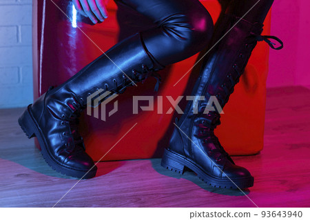Young woman wearing fashionable boots Young woman wearing fashionable boots 93643940