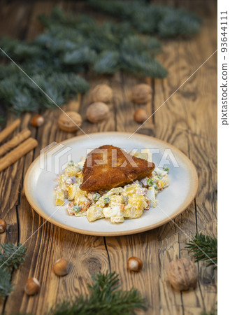 Traditional Christmas dinner in Czech Republic - carp fillet with potato salad Traditional Christmas dinner in Czech Republic - carp fillet with potato salad 93644111