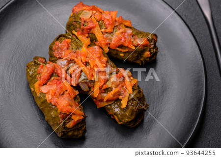 Dolma, stuffed grape leaves with rice and meat on a dark background 93644255