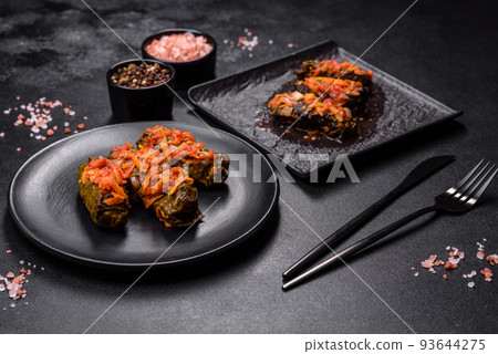 Dolma, stuffed grape leaves with rice and meat on a dark background 93644275