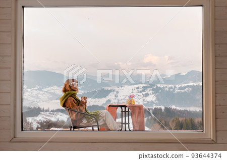 Woman on terrace at rest house in the mountains 93644374