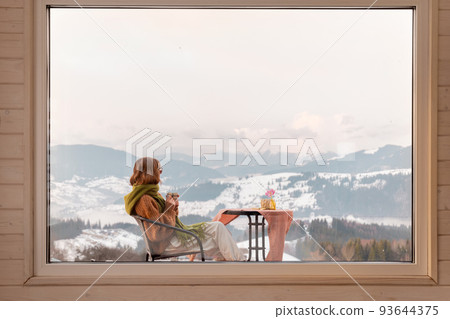 Woman on terrace at rest house in the mountains Woman on terrace at rest house in the mountains 93644375