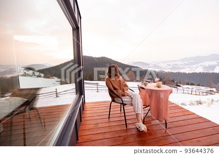 Woman resting at small house in the mountains 93644376
