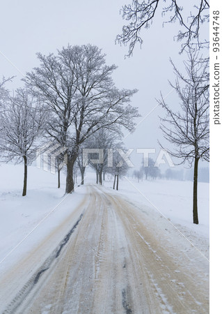 Dusty road with fresh snow 93644748