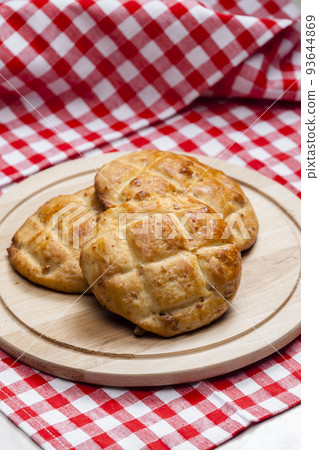 cracklings buns on wooden board 93644869