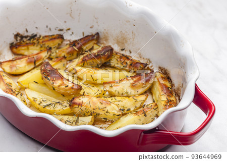 still life of baked potatoes with herbs 93644969
