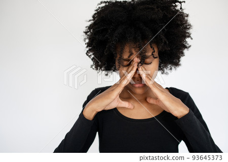 Close-up of face of stressed African American woman Close-up of face of stressed African American woman 93645373