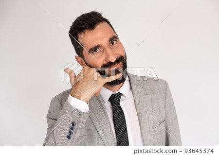 Handsome bearded man making call me gesture Handsome bearded man making call me gesture 93645374