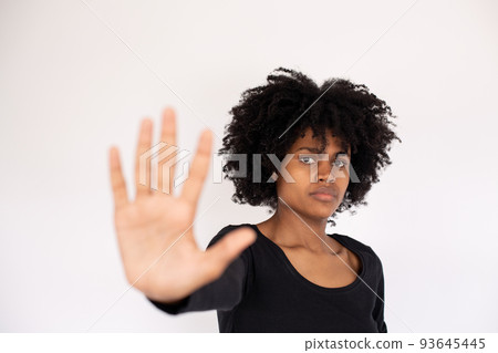 Close-up of serious African American woman making stop gesture Close-up of serious African American woman making stop gesture 93645445