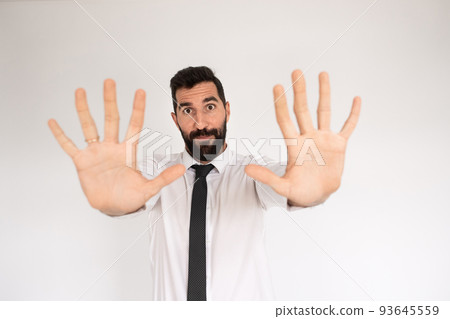 Handsome bearded man making stopping gesture 93645559