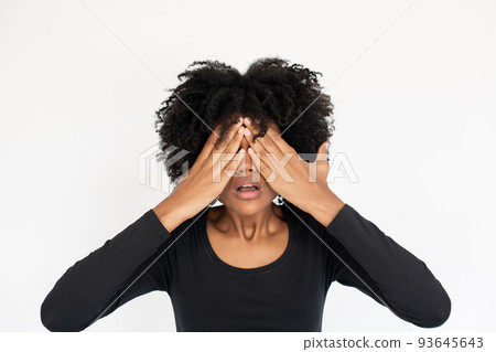 Portrait of stressed African American woman covering eyes Portrait of stressed African American woman covering eyes 93645643