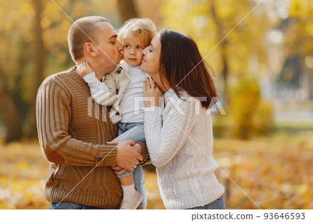 Family with cute little daughter. Father in a brown sweater. Family in a autumn field 93646593