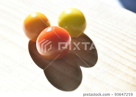 Taking pictures of mini tomatoes placed on the table in the morning sun Taking pictures of mini tomatoes placed on the table in the morning sun 93647259